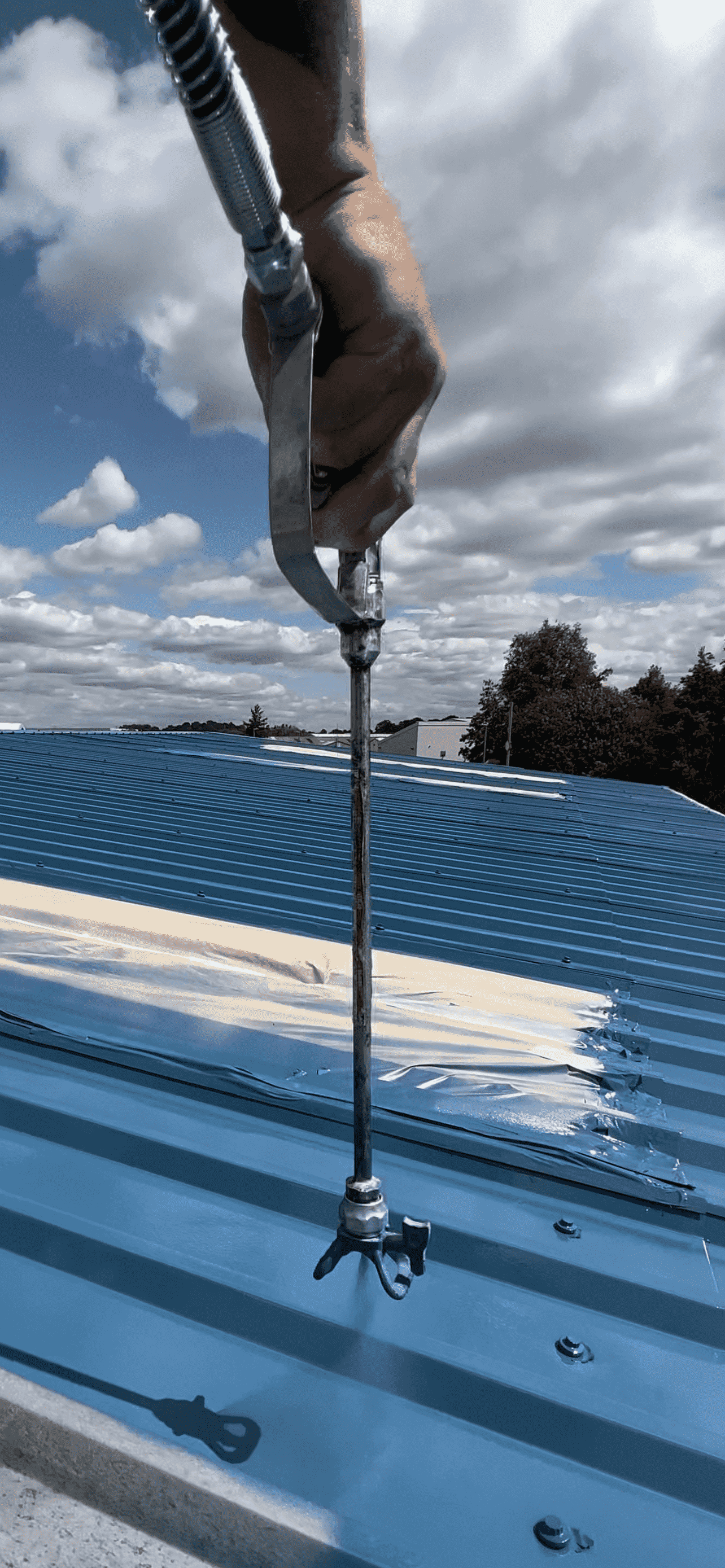 Commercial painter applying paint to exterior wall